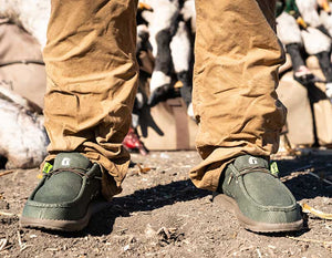 closeup from the front of man wearing Gator Waders Camp shoes in the green color. 